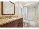 Bathroom featuring granite countertops, dark wood cabinets, and a shower/tub combo at 3252 Scorecard Dr, New Port Richey, FL 34655