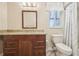 Bathroom with granite countertops, wood cabinetry and a shower/tub combo at 3252 Scorecard Dr, New Port Richey, FL 34655
