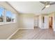 Spacious bedroom with light wood flooring, double closets and a ceiling fan at 3252 Scorecard Dr, New Port Richey, FL 34655