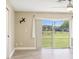 Bedroom with wood-look flooring and sliding glass door to the outside at 3252 Scorecard Dr, New Port Richey, FL 34655