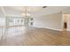 Open-concept living space with new flooring and a staircase with white railings at 3252 Scorecard Dr, New Port Richey, FL 34655