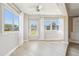 Bright living room featuring lots of natural light, light wood flooring and a modern ceiling fan at 3252 Scorecard Dr, New Port Richey, FL 34655
