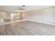 Bright and airy living room featuring modern floors and easy access to the kitchen at 3252 Scorecard Dr, New Port Richey, FL 34655