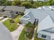 Aerial view of a home with grey roof, green grass, and mature trees at 3254 Lori Ln, New Port Richey, FL 34655