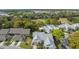Aerial view features neighborhood homes with mature trees, lush shrubs, and green lawns at 3254 Lori Ln, New Port Richey, FL 34655