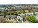 An aerial view showcases neighborhood homes near commercial areas and tree-lined streets at 3254 Lori Ln, New Port Richey, FL 34655