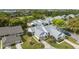Aerial view of a home with grey roof, green grass, and mature trees at 3254 Lori Ln, New Port Richey, FL 34655