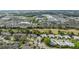 Aerial view features neighborhood homes with nearby shops, and commercial district at 3254 Lori Ln, New Port Richey, FL 34655