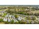 An aerial view of homes nestled in a community near a golf course, trees, and a serene lake at 3254 Lori Ln, New Port Richey, FL 34655