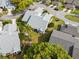An aerial view of a well-maintained home featuring mature landscaping and a light gray roof at 3254 Lori Ln, New Port Richey, FL 34655
