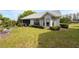 The backyard has beautiful green grass, lush shrubs, and mature trees at 3254 Lori Ln, New Port Richey, FL 34655