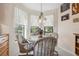 Bright breakfast nook featuring a chandelier and windows showcasing the outdoors at 3254 Lori Ln, New Port Richey, FL 34655