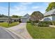 Charming single-story home with neutral siding, attached garage, manicured lawn, and American flag at 3254 Lori Ln, New Port Richey, FL 34655