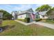 Well-maintained one-story home featuring a manicured lawn, attached garage, and an American flag at 3254 Lori Ln, New Port Richey, FL 34655