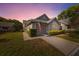 Charming home with a well-maintained lawn and an American flag hanging over the garage door at 3254 Lori Ln, New Port Richey, FL 34655