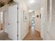 Hallway features wood-look flooring, access to bedrooms and bathrooms, and natural light at 3254 Lori Ln, New Port Richey, FL 34655