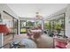 Enclosed porch features a ceiling fan, and furniture to enjoy the weather at 3254 Lori Ln, New Port Richey, FL 34655