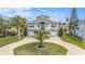 An aerial view of a waterfront house showcasing the front yard with circular drive at 3432 Bluefish Dr, Hernando Beach, FL 34607