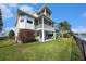 A backyard with patio seating and a view of the house, which includes both screened and unscreened porches at 3432 Bluefish Dr, Hernando Beach, FL 34607