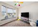 Bright bedroom featuring large window seat, wall-mounted television, and colorful fan at 3432 Bluefish Dr, Hernando Beach, FL 34607