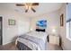 Comfortable bedroom features a beach themed wall mural, soft carpet, and a ceiling fan at 3432 Bluefish Dr, Hernando Beach, FL 34607