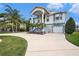 Charming two-story home with a well-maintained lawn, a long driveway, and an attached garage at 3432 Bluefish Dr, Hernando Beach, FL 34607