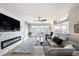 Open living room boasts a modern fireplace, ceiling fan, and plush rug with easy access to outdoor living at 3432 Bluefish Dr, Hernando Beach, FL 34607