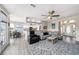 Open-concept living area includes a dining space, plush rug, and a peek into the well-lit kitchen at 3432 Bluefish Dr, Hernando Beach, FL 34607