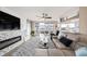 Sun-lit living space featuring a modern fireplace, plush rug, and seamless access to an outdoor balcony at 3432 Bluefish Dr, Hernando Beach, FL 34607