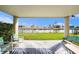 Charming covered patio featuring comfortable seating and picturesque water views, perfect for relaxing and entertaining at 3432 Bluefish Dr, Hernando Beach, FL 34607