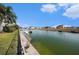 Picturesque waterfront featuring boat dock and scenic views of neighboring homes under a partly cloudy sky at 3432 Bluefish Dr, Hernando Beach, FL 34607