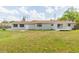 Spacious backyard featuring lush green grass and a bright home at 3502 Bloomingdale Ave, Valrico, FL 33596