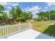 White wooden deck overlooking a large backyard with lush green grass and a wooden fence surrounding the property at 3502 Bloomingdale Ave, Valrico, FL 33596
