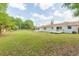 Large grassy backyard with a view of a white home at 3502 Bloomingdale Ave, Valrico, FL 33596