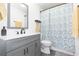 Bathroom featuring a modern vanity, toilet, and shower/tub combination with a stylish floral curtain at 3502 Bloomingdale Ave, Valrico, FL 33596