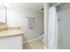 Bathroom with walk-in shower, granite vanity, tile floors, towel rack, exhaust fan, and standard toilet at 3502 Bloomingdale Ave, Valrico, FL 33596