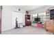 Bedroom with a TV, a shelf, and a sliding door closet filled with personal items at 3502 Bloomingdale Ave, Valrico, FL 33596