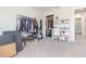 Bedroom with clothes rack, closet, desk, chair, and neutral paint at 3502 Bloomingdale Ave, Valrico, FL 33596