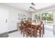Cozy dining area with a wooden table, seating for six, and a sliding glass door leading to the outdoors at 3502 Bloomingdale Ave, Valrico, FL 33596