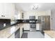 Modern kitchen with updated appliances, granite countertops, and plenty of storage space in white cabinetry at 3502 Bloomingdale Ave, Valrico, FL 33596