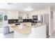 Bright kitchen with stainless steel appliances, granite countertops, black tile backsplash and breakfast bar seating at 3502 Bloomingdale Ave, Valrico, FL 33596