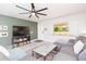 Comfortable living room with a large sectional sofa, modern ceiling fan, and neutral color palette at 3502 Bloomingdale Ave, Valrico, FL 33596