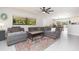 Bright and airy living room with a ceiling fan, an open floor plan, and views into the kitchen and dining areas at 3502 Bloomingdale Ave, Valrico, FL 33596