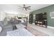 Bright and airy living room with a ceiling fan, an open floor plan, and views into the kitchen and dining areas at 3502 Bloomingdale Ave, Valrico, FL 33596