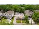 Aerial view of charming home with inviting front porch, manicured lawn, and mature palm trees at 3512 W Santiago St, Tampa, FL 33629