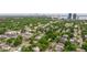 Aerial view showcases a vibrant neighborhood near the city and beautiful, mature landscaping at 3512 W Santiago St, Tampa, FL 33629