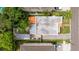 Bird's eye view reveals the house layout including an orange tile roof and lush backyard trees at 3512 W Santiago St, Tampa, FL 33629