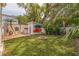 Backyard featuring a fire pit, kayaks, and lush landscaping at 3512 W Santiago St, Tampa, FL 33629