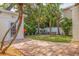 Serene backyard with lush landscaping, brick pavers, and firepit at 3512 W Santiago St, Tampa, FL 33629
