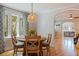 Dining room featuring a round wood table, patterned curtains, and a modern light fixture at 3512 W Santiago St, Tampa, FL 33629